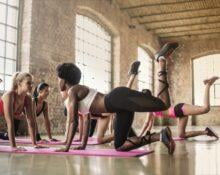 Women Doing Yoga Class on Pink Yoga Mat