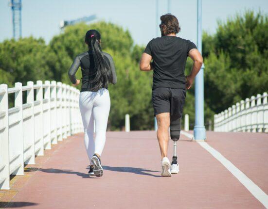 Man and woman jogging outdoors in a park