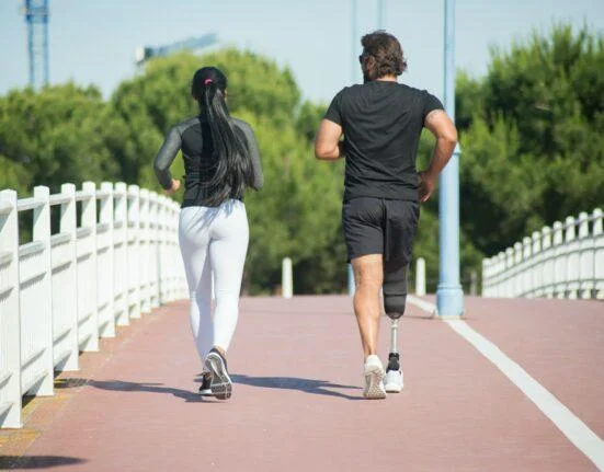 Man and woman jogging outdoors in a park